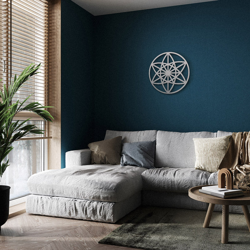 Home Wall Decor Metal Wall Art Sacred Geometry Art Vector Equilibrium in silver, Hanging in a living room, on a green wall, with a beige sofa, a flowerpot and a half-open window with natural light.