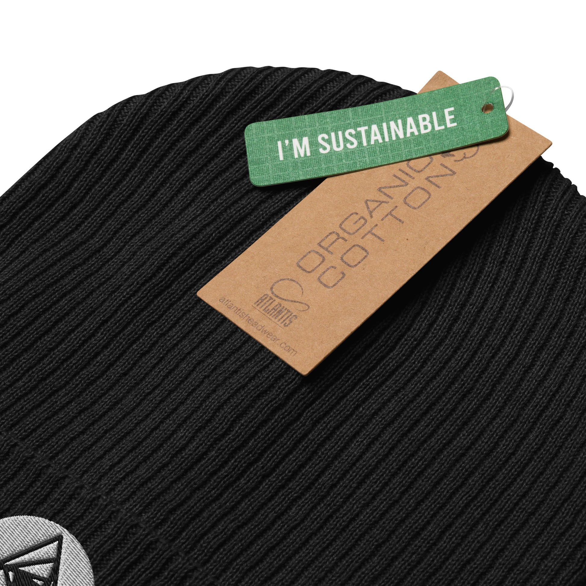 Behold, our Spiraling Equilateral Triangles Beanie in midnight black —a garment of cosmic significance. Crafted from organic cotton and adorned with a mesmerizing Spiraling Equilateral Triangles embroidery, it's not your run-of-the-mill hat. with a label of "I'M SUSTAINBLE"