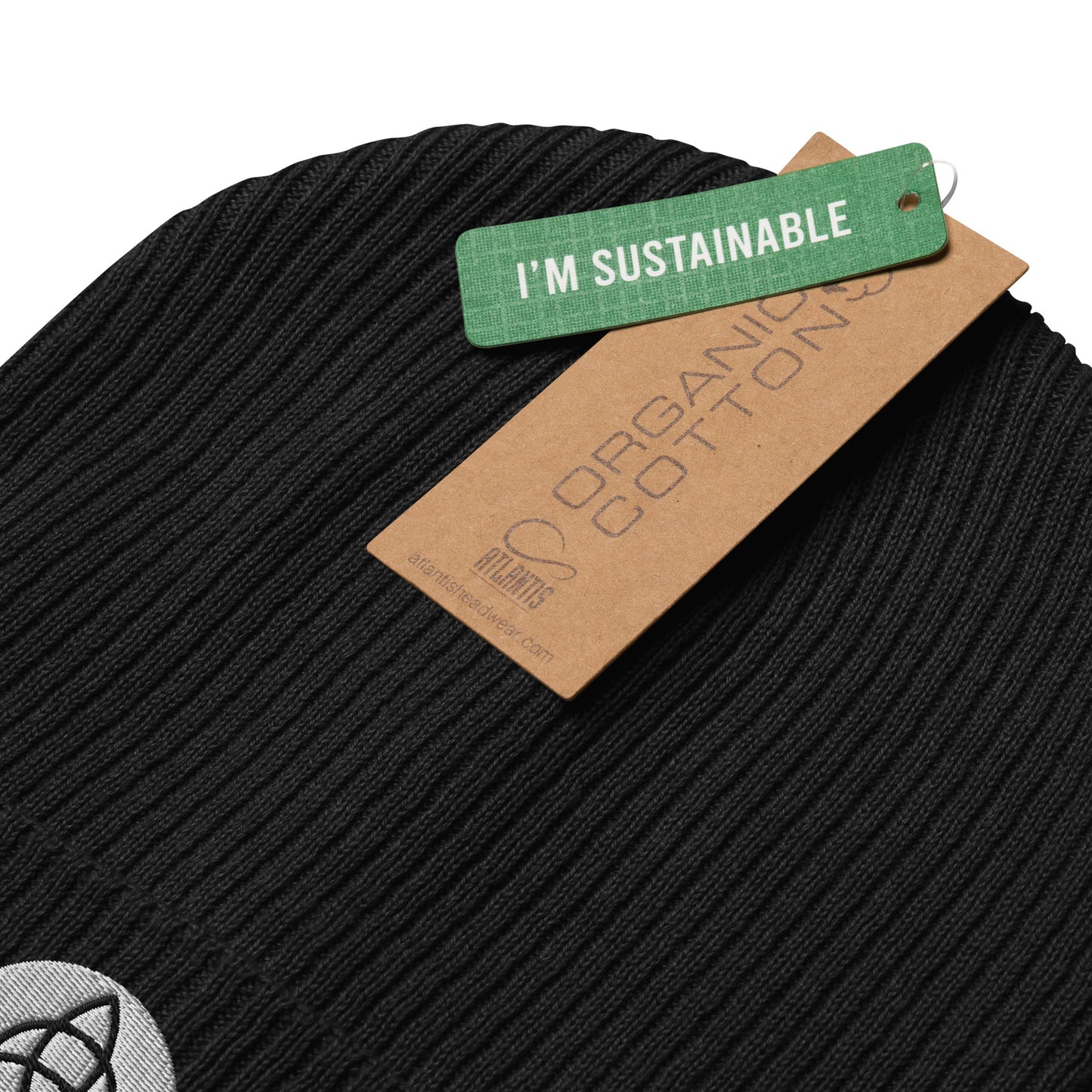 A ribbed beanie in Midnight Black hat made of organic cotton, embroidered with a Triquetra symbol, symbolizing unity, eternity, and the interconnectedness of mind, body, and spirit. This organic ribbed beanie is chic, versatile, and environmentally conscious, making it an essential addition to your hat collection. Crafted from breathable lightweight fabric, it's suitable for both indoor and outdoor wear. Made with hypoallergenic and natural materials. with a label of I'M Sustainable